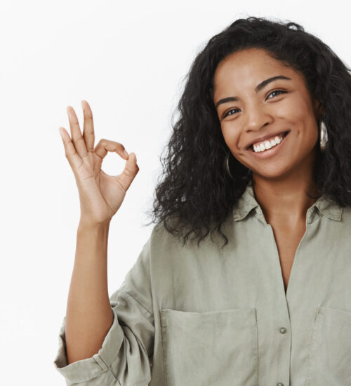 Okay I do it. Portrait of charming friendly and polite happy african american adult woman in blouse tilting head and smiling broadly showing ok or excellent gesture liking perfect new office design Okay I do it. Portrait of charming friendly and polite happy african american adult woman in blouse tilting head and smiling broadly showing ok or excellent gesture liking perfect new office design